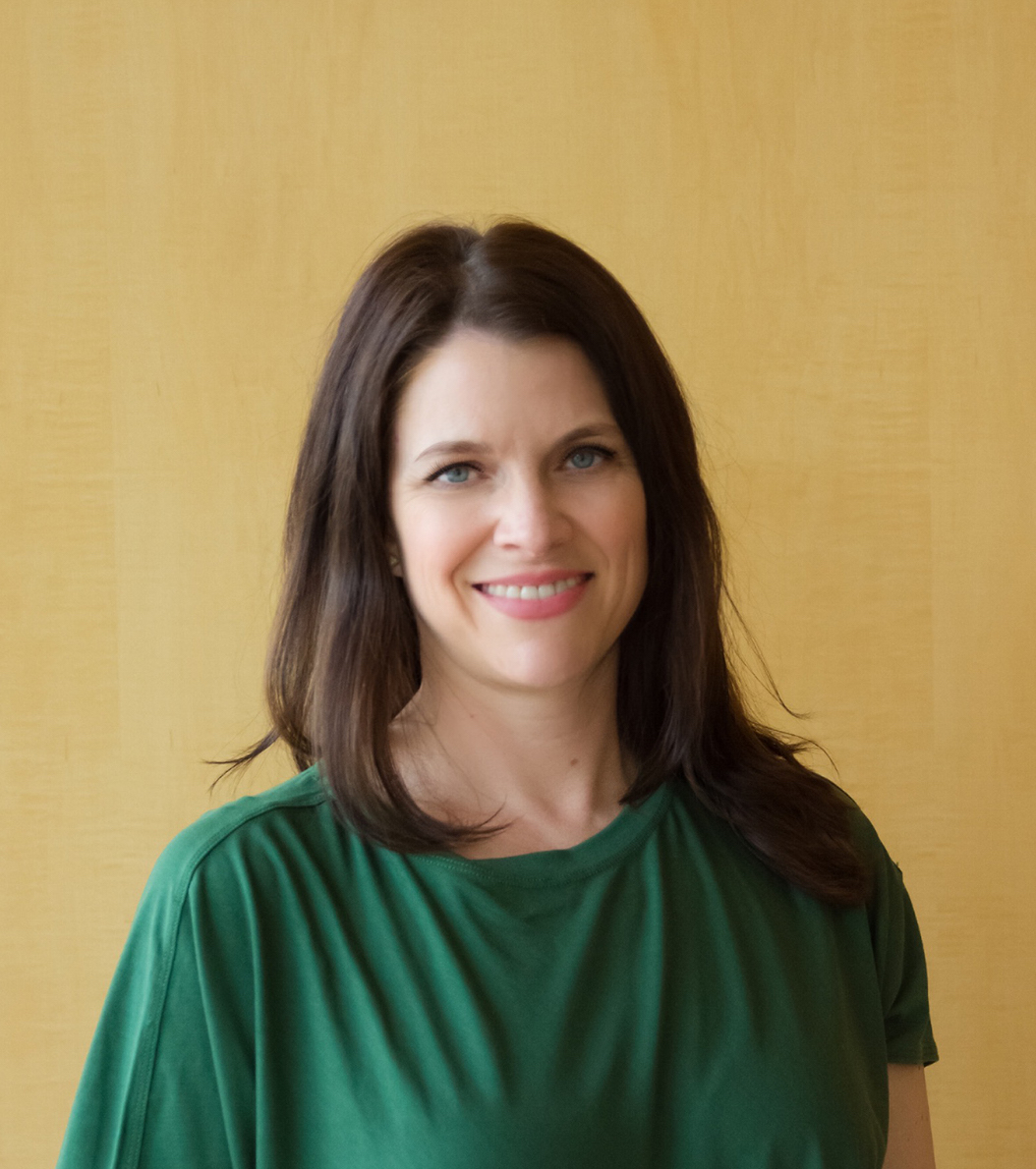 Headshot of Melanie wearing a green shirt 